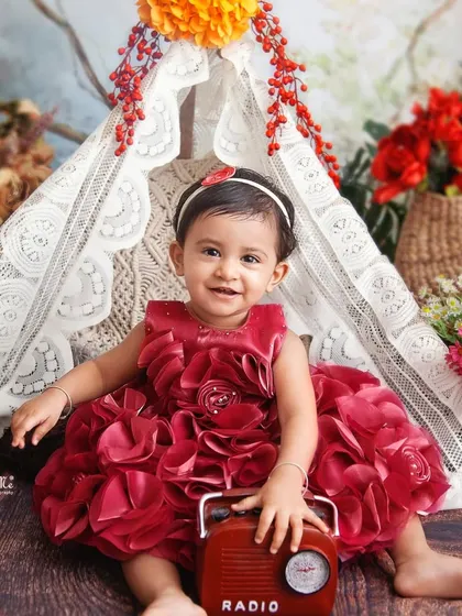 A big smile from the birthday girl. The vintage radio prop adds a fun and quirky touch to this beautiful floral scene.