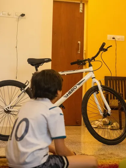 A student looks over the fully reassembled bicycle, a look of accomplishment on their face. This is the moment they realize they have the skills to do it themselves.