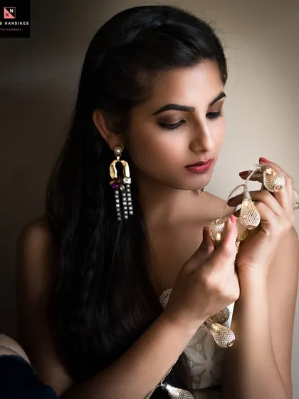 A warm and intimate portrait where the model holds a string of fairy lights. The soft glow from the lights creates a cozy and gentle mood, perfect for a relaxed studio session.