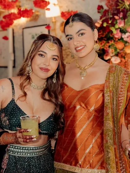A beautiful shot of friends celebrating at a Mehendi. Both looks are soft and elegant, tailored to their individual styles and outfits.