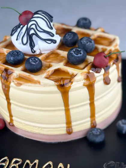 Sweeten your day with our waffle-themed cake. Combining the best of breakfast and dessert, it’s a stack of joy with every slice, drizzled with syrup and topped with berries.