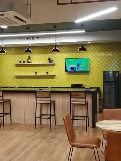 A clear shot of the pantry and cafe bar at VentureX. The design is both practical and stylish, with open shelving, modern appliances, and ample seating for employees.