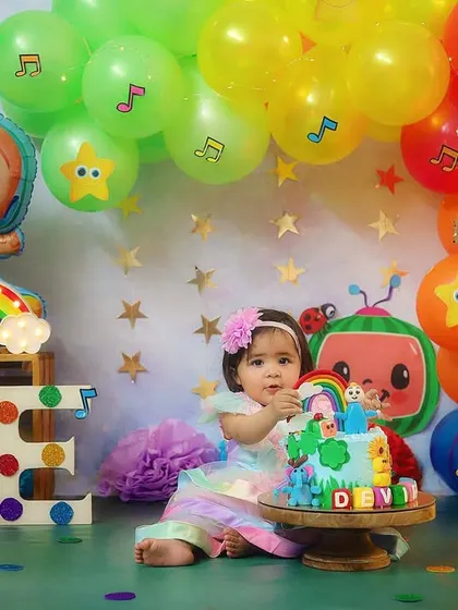 For the biggest Cocomelon fans! This colorful setup brings the popular show to life for a very happy first birthday girl.