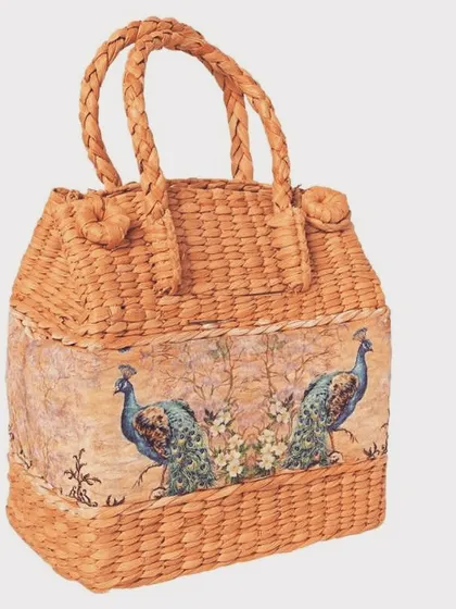 Our sea grass tiffin or picnic basket is a charming and sustainable way to carry your lunch. The design, featuring a printed fabric panel with peacocks, adds a touch of traditional Indian art to a functional item.