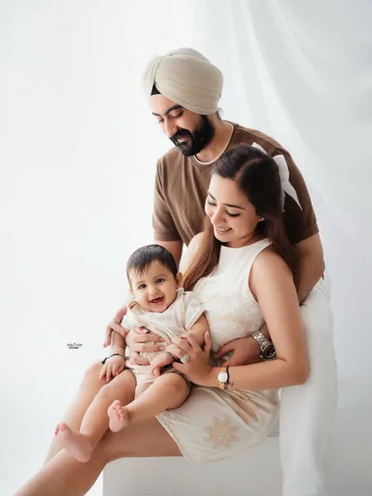 A classic family pose, with everyone smiling for the camera. A perfect keepsake.
