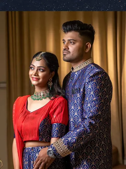 The couple together: her blue and red lehenga is paired with his royal blue brocade sherwani.
