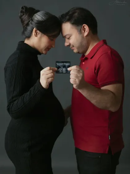 Sharing a look at their baby's first photo. Using the ultrasound scan is a wonderful way to include the baby in the maternity session.