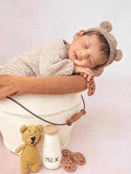 The complete milk and cookies setup, with the baby bear in a bucket next to his teddy bear friend.