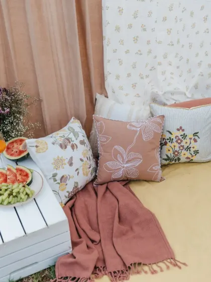 Another look at our 'Pause' collection cushions, featuring a mix of floral prints, line art, and striped patterns in a cohesive color palette of dusty rose and muted greens.