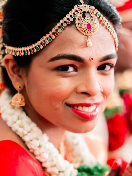 A radiant close-up of the bride, her smile lighting up the frame during her South Indian wedding ceremony.