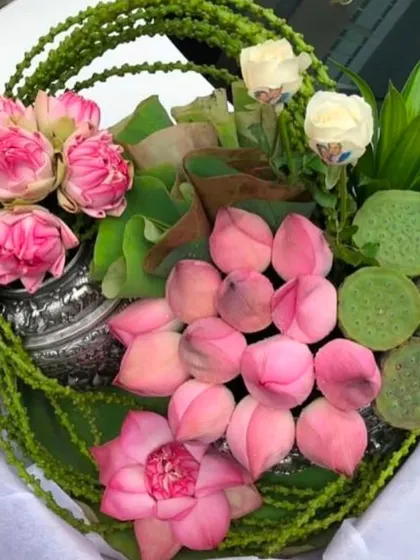 An intricate and creative arrangement made with pink lotus flowers, buds, and seed pods. This showcases my ability to work with traditional flowers in a modern and artistic way for festive decor.