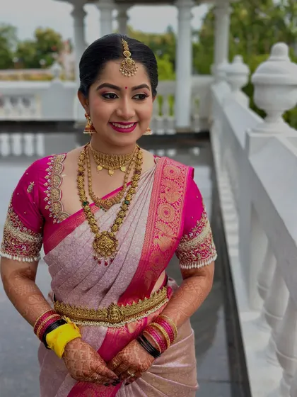 This bride is the picture of happiness. Her makeup is designed to be photogenic from every angle, with a focus on bright, open eyes and a perfectly applied lipstick.