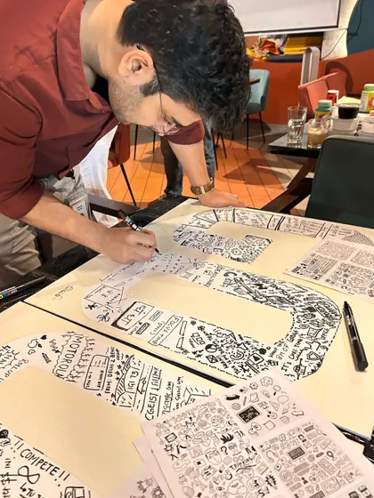 A Googler completely focused on adding his personal touch to the team's collaborative art piece. These doodling sessions allow for both individual expression and group synergy.