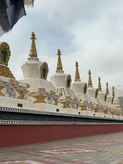 A row of stupas stands as a testament to faith at a Ladakhi monastery. The landscape here is not just a backdrop but an active participant in our journey of self-discovery.