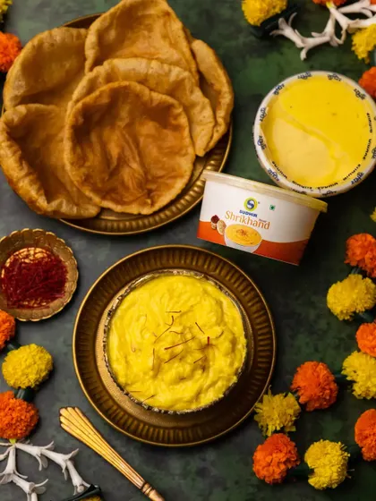 This shot includes the product packaging for the Shrikhand, making it a perfect image for brand advertising or e-commerce listings.
