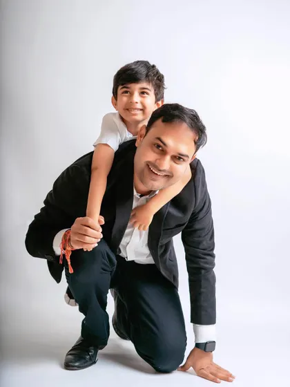 A fun piggyback ride for a son on his dad's back. Capturing these playful father-son moments is always a joy.