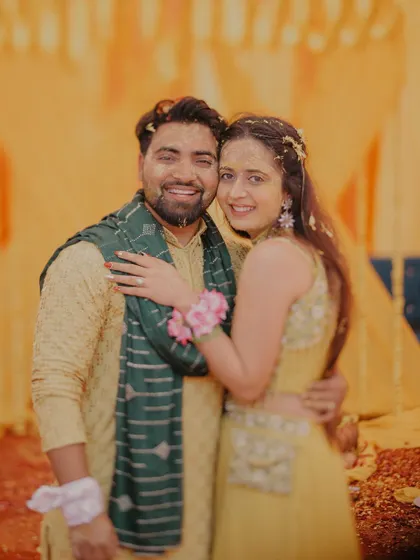 A happy portrait of the couple, their faces glowing with turmeric and love during their Haldi ceremony.