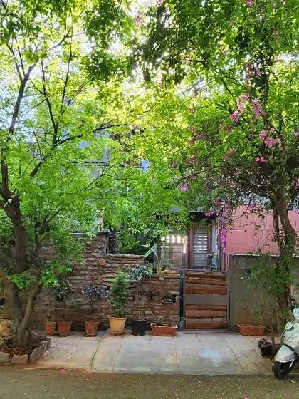 My studio as seen from the street in spring, almost hidden by the lush trees. I designed the building to coexist with its green surroundings, allowing nature to be the true facade.