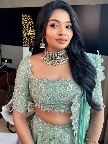 A beautiful client ready for her engagement. The mint green outfit is paired with soft makeup and loose waves.