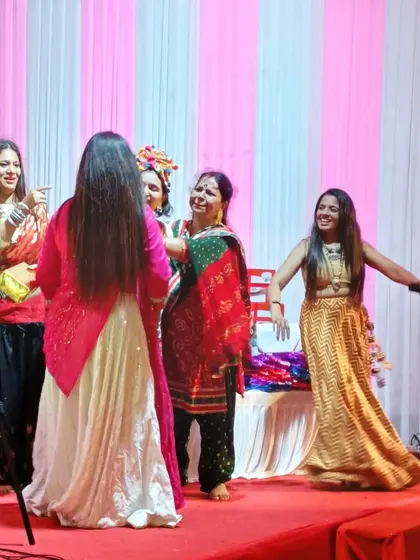 Sharing a dance on stage with guests at a Navratri event. It's all about celebrating together and sharing the joy of the festival.