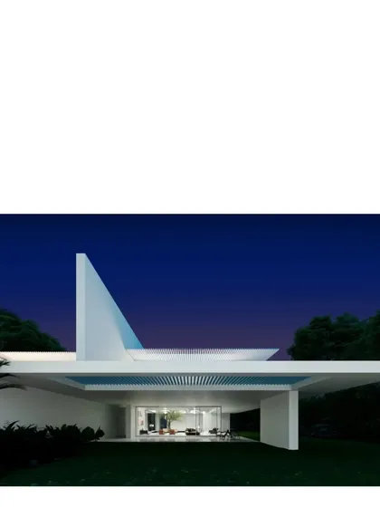 The sculptural form of the Koba House at dusk. The design is elemental, using clean white planes and a dramatic roofline to create a powerful statement against the deep blue sky.