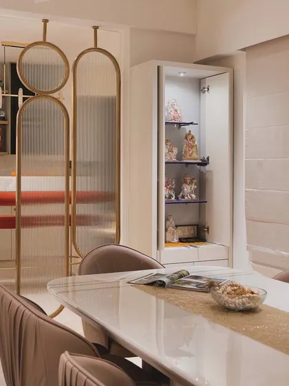 This view shows the clever integration of a compact, modern pooja unit right next to the dining space, making it a functional and beautiful part of everyday life.
