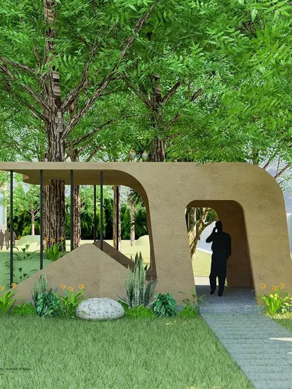 This perspective of the anthill-inspired structure shows the pathway leading through it. The organic openings and curved form invite exploration and interaction, making it more than just a shelter.