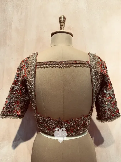 The stunning broad back of Bhavana's reception blouse, with modern cuts and heavy latkans.