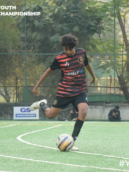 A player winds up for a powerful shot on goal during a Youth Championship match.