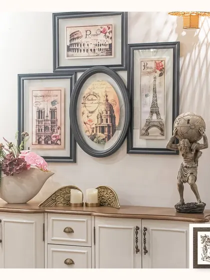 This gallery wall arrangement features a collection of memorabilia-style frames showcasing famous European landmarks. The mix of rectangular and oval frames creates a dynamic and visually interesting display.