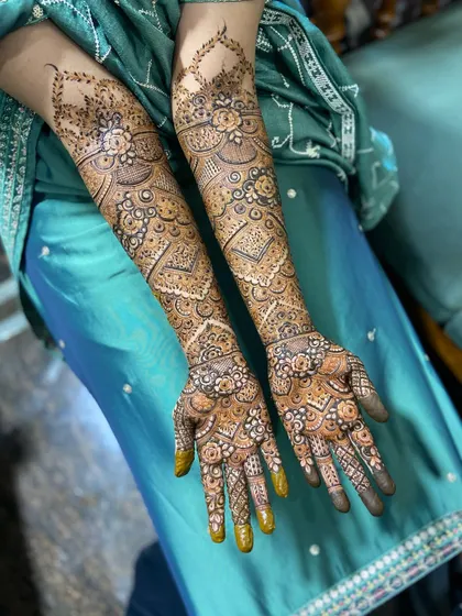 Another angle of this stunning full bridal mehendi, showing the intricate details on the back of the hands and arms.
