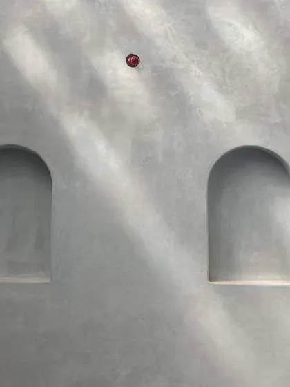 The subtle play of light on a grey wall with arched niches in our Chickmagalore estate villa.