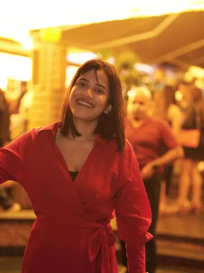 A guest in a vibrant red dress, enjoying the high-energy affair at Pangeo.