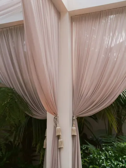 A close-up of the soft, flowing drapes tied back with elegant tassels. This detail shows the quality of materials and the refined finishing touches that I bring to my decor.