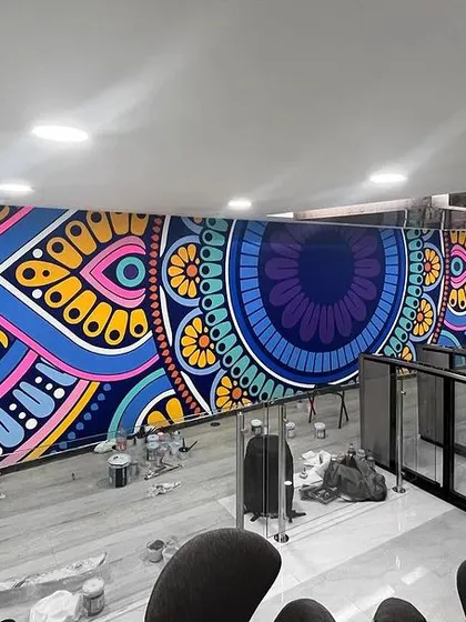 A full view of the sprawling mandala mural for Skyhigh Security. The bright colors and intricate patterns create a captivating and energetic atmosphere in the corporate entryway.