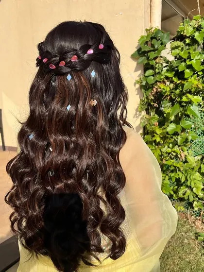 Shine bright like a diamond. For this look, I used a waterfall braid and scattered tiny mirror-like gems through the curls for a sparkling effect.