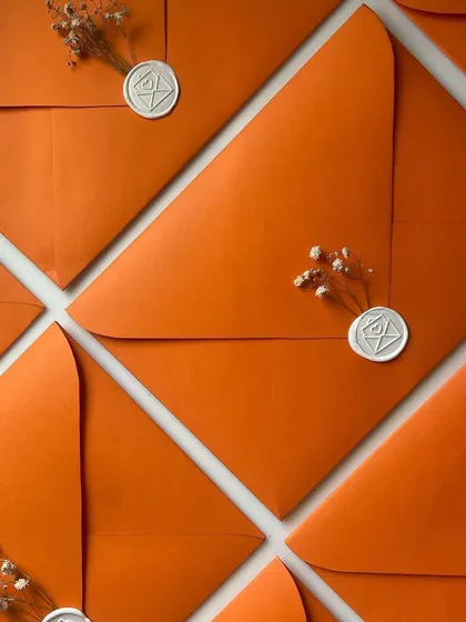 There's something so elegant and timeless about a perfectly sealed envelope. I love using different colors, from vibrant orange and green to classic grey vellum, each finished with a custom wax seal.