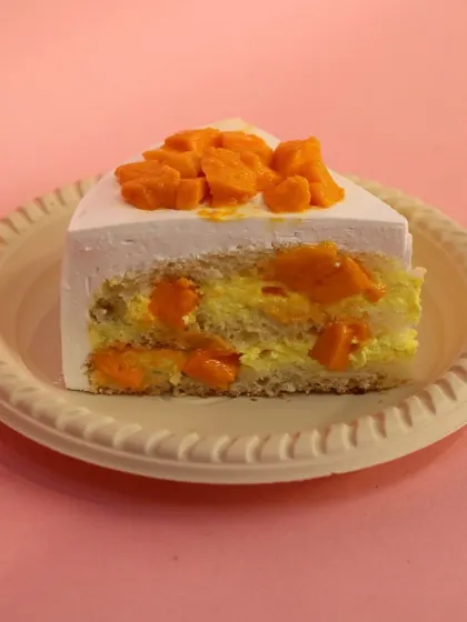 A slice of our fresh Mango Pastry, filled and topped with chunks of sweet, juicy mango.