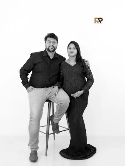 A sophisticated black and white version of a modern couple's portrait. The high contrast and simple background create a timeless and artistic feel.