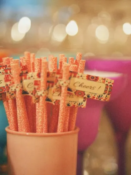 Custom stirrers with a "Cheers!" flag. It's the small, personalized details like this that make a party feel cohesive and thoughtfully planned.