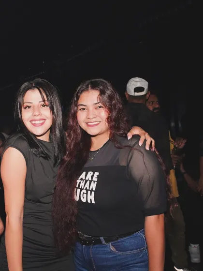 Friends posing for a photo, enjoying the vibrant nightlife scene in Dubai.