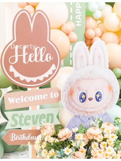 A custom welcome sign and character props for the Labubu-themed birthday party entrance.