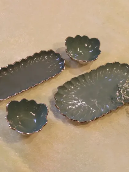 Our enamel serveware comes in various shapes and sizes, like these scalloped platters and bowls. They are perfect for creating a coordinated buffet spread.
