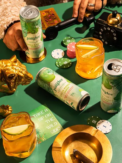 A creative shot of canned cocktails in a casino-themed setting, using props to build a specific mood and narrative.