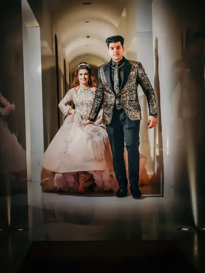 A dynamic shot of the couple making their entrance. Their confident stride and coordinated high-fashion outfits create a powerful and stylish image.