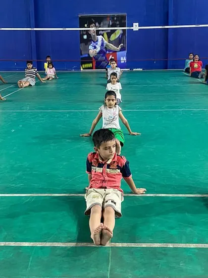 Young players practicing seated stretches during a yoga session. I believe in a holistic approach to training, where physical conditioning is balanced with practices that promote recovery and mental well-being.