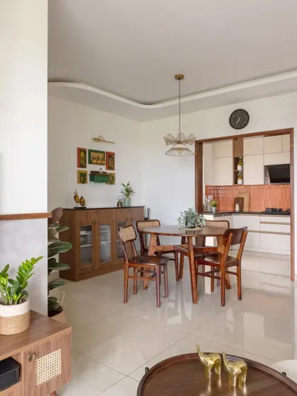 A wide view of the common area, showing the seamless flow between the living room, dining area, and kitchen.
