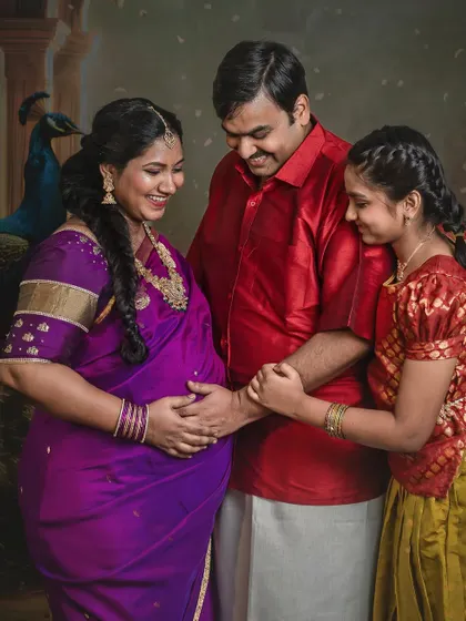 A joyful family moment where the husband and daughter gently touch the mother's baby bump. Their shared smiles and connection make this a warm and loving maternity portrait.