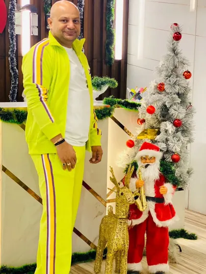 Festive vibes, elite tribe. A member poses by our Christmas decorations, showcasing the warm and celebratory atmosphere at the club.