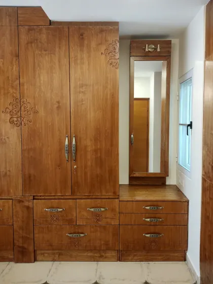 A duplicate of image 2, showing the beautifully crafted wooden wardrobe and dresser combination.